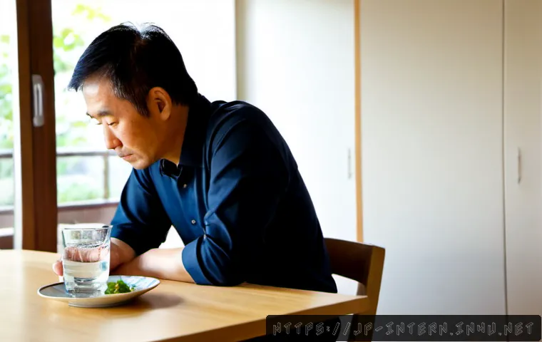 간암 초기 증상 - Photorealistic Japanese middle-aged man sitting quietly at a clean kitchen table, one hand resting g...